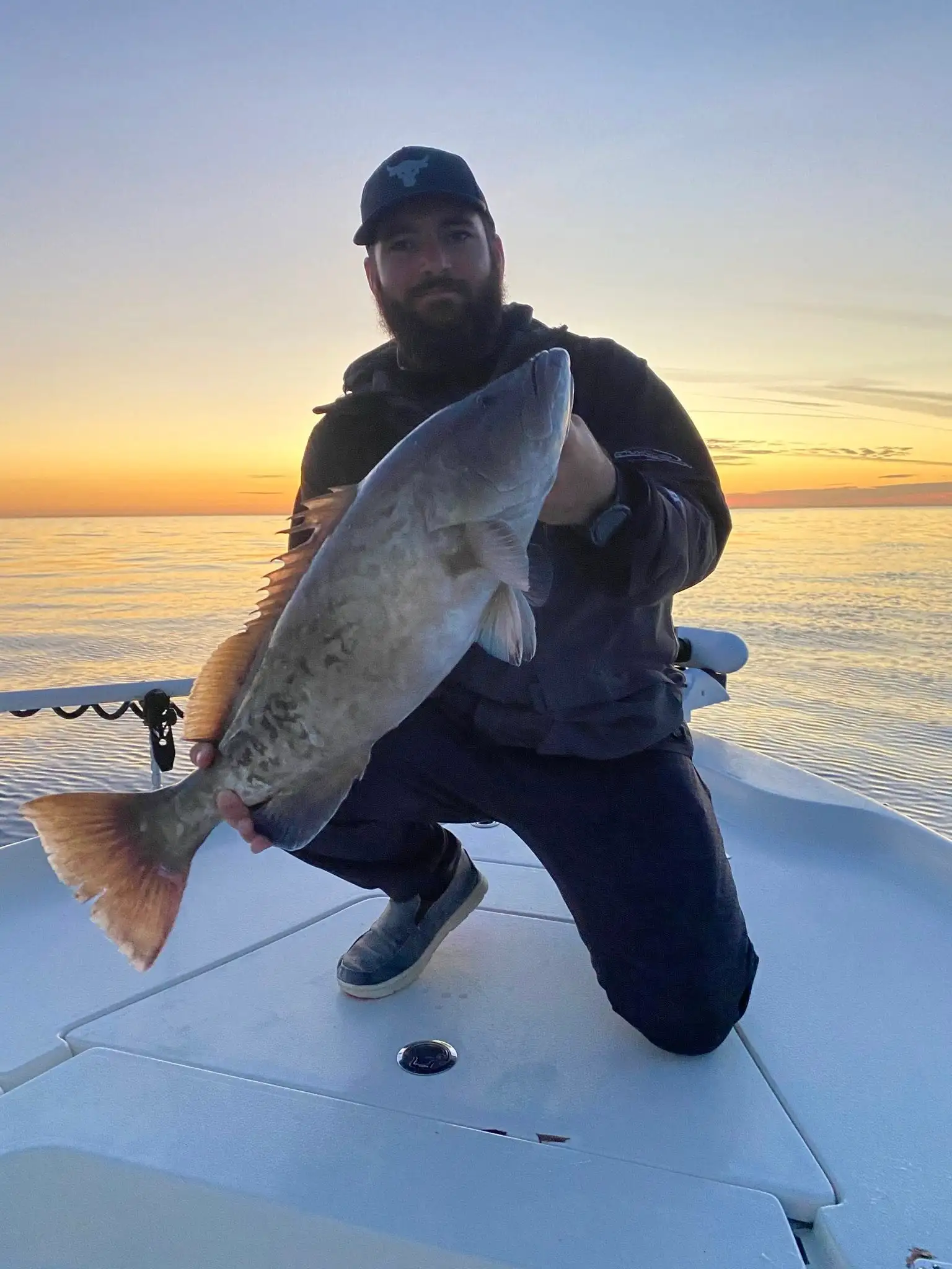 Customer holding a gag grouper caught on a Tampa Bay fishing charter