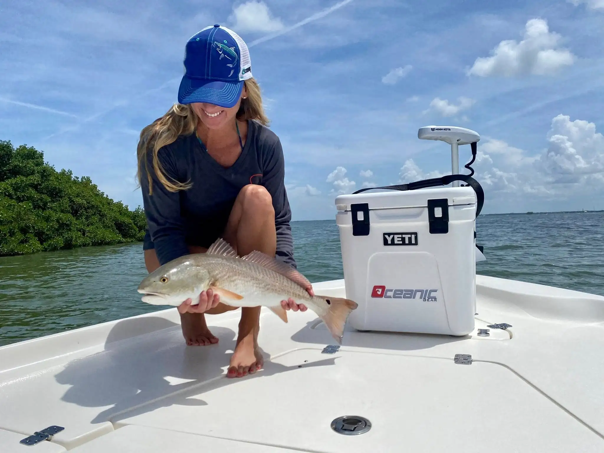 Happy customer showing her catch on a Tampa inshore fishing trip